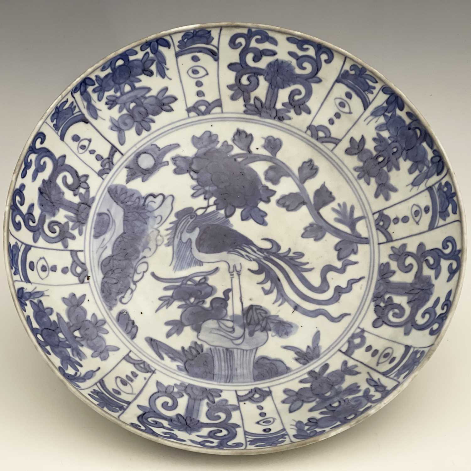 A Chinese blue and white dish, Ming, painted with a bird on rock with peony design, within a