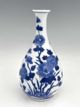 An Oriental blue and white vase, teardrop bottle form, painted with chrysanthemums and lotus flowers
