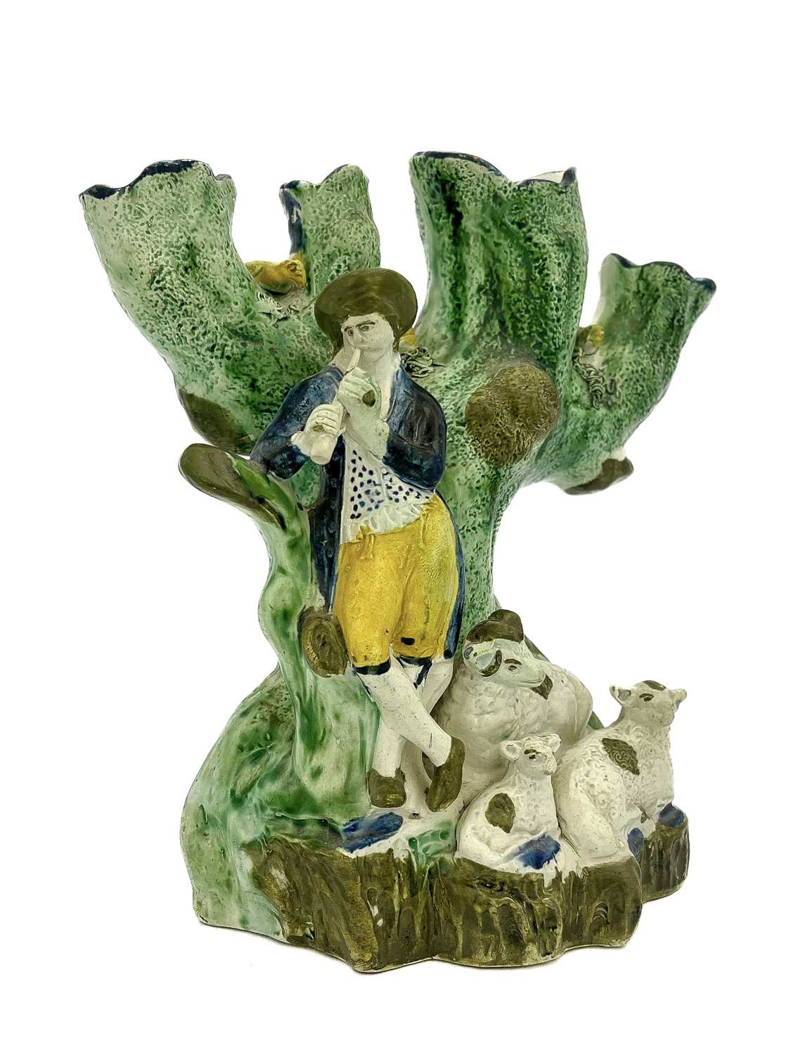 A Staffordshire four branch Prattware tulip vase, circa 1790, modelled as a piping shepherd with