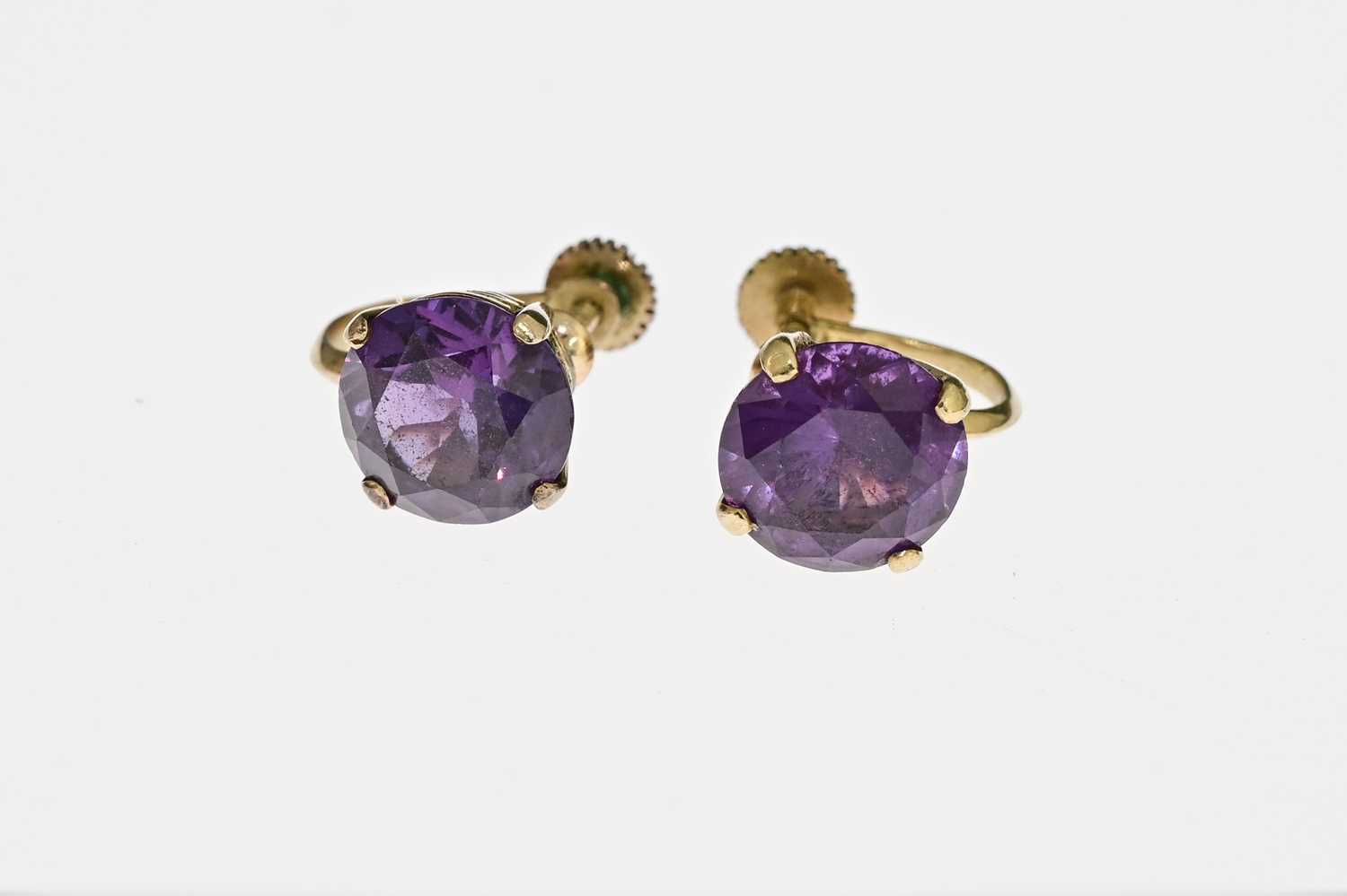 A pair of 14 carat gold and synthetic colour change sapphire earrings, screw fixing, 1cm diameter,