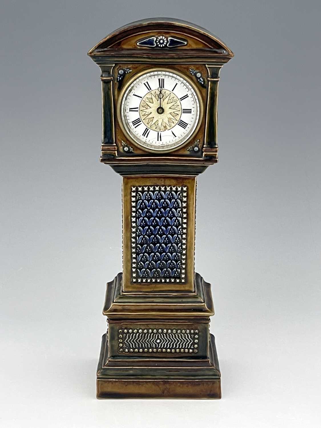 A Doulton stoneware novelty time piece, 1884, modelled as a longcase clock, moulded foliate panels