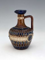 A Doulton Lambeth stoneware jug, shouldered bulbous form, sgraffito decorated and relief moulded