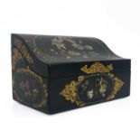 A Japanned papier mache stationary box, cuboid form with hinged piano lid, painted and inset with