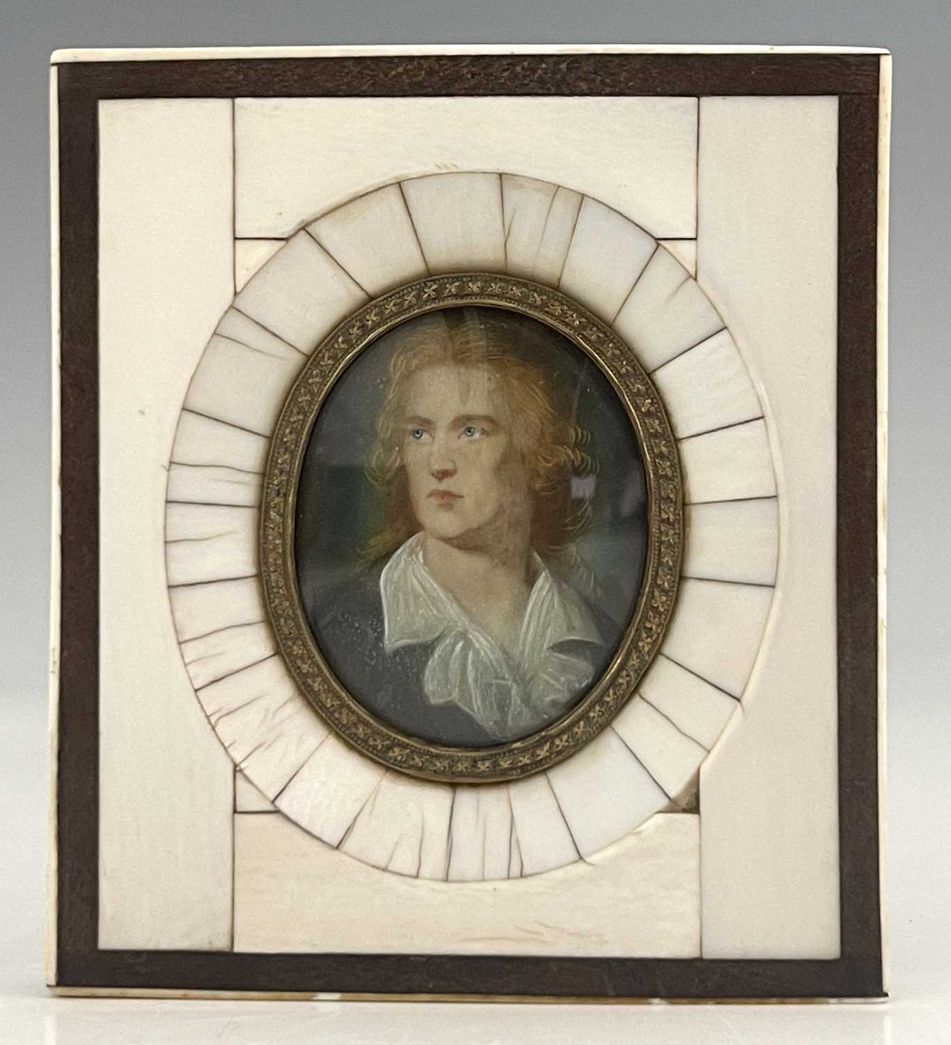 A pair of 18th-century portrait miniatures finely painted to depict a bewigged man in a purple