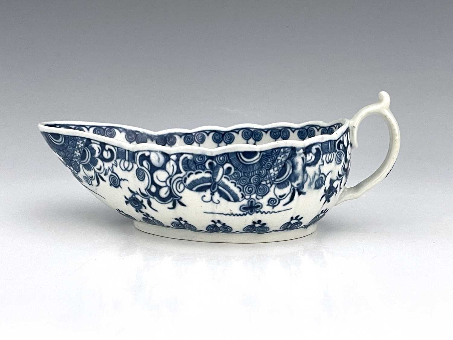 A Worcester blue and white sauce boat, circa 1765-70, reeded form, painted with the Donut pattern to