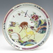 A Chinese famille rose dish, enamelled with deer in a garden landscape, within geometric and foliate