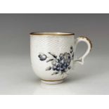 A Bristol porcelain coffee cup, cross mark, circa 1770, rattan moulded border above blue