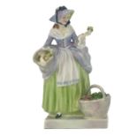 A Royal Doulton figure, Spring Flowers, model HN1807, in a green skirt and purple corset, printed