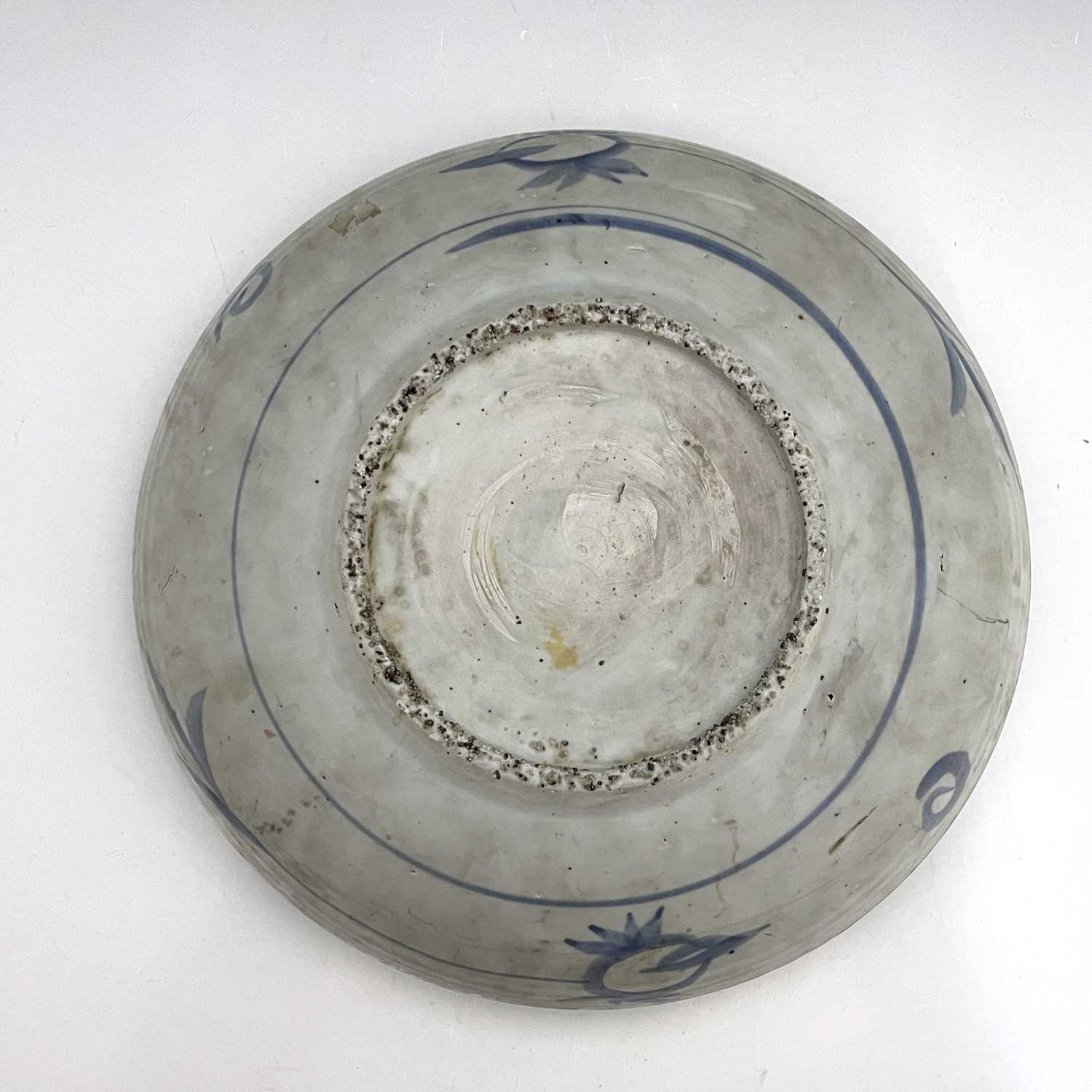 A Chinese blue and white dish, Ming, painted with a bird on rock with peony design, within a - Image 2 of 5