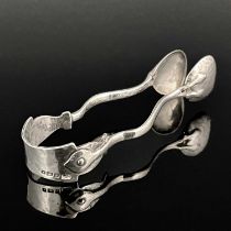 A pair of Arts and Crafts silver sugar tongs, Mappin and Webb, Birmingham 1906, planished with