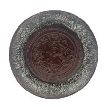 Christopher Dresser for Linthorpe, an art pottery plate, dust pressed in relief with a bird and