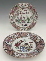 Two Chinese famille rose plates, one painted with a garden landscape of figures beneath a prunus