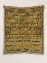 A George III sampler, by Ann Hammond, aged 9, dated 1812, embroidered with the alphabet, numbers and