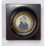 An early 19th century portrait miniature painted to depict a man in a high-collared blue coat, on