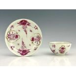 A Worcester tea bowl and sacucer, circa 1765, painted in the Meissen style with puce floral