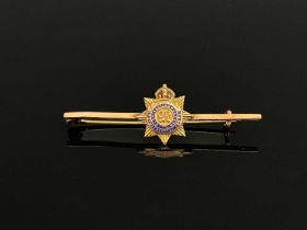 A 9 carat gold and enamelled Roal Army Service Corps bar brooch, applied 8 pointed star on plain