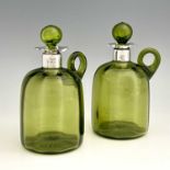 A pair of Arts and Crafts silver mounted green glass whisky flagons, William Hutton and Sons,