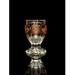A Bohemian heraldic cameo glass vase, circa 1835, heavy slice cut chalice form with petal base,