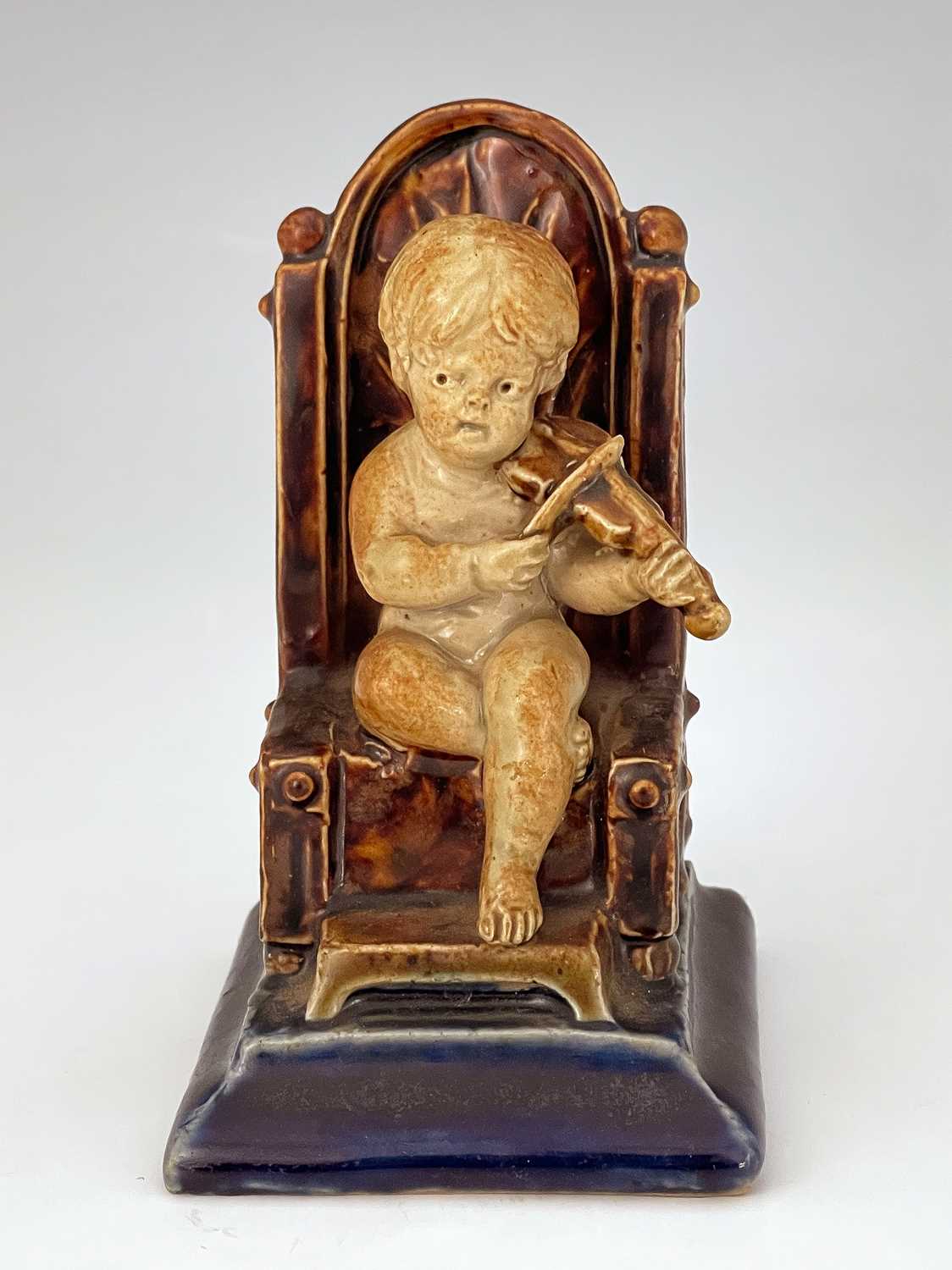 George Tinworth for Doulton Lambeth, a stoneware figural menu holder, modelled as a child playing