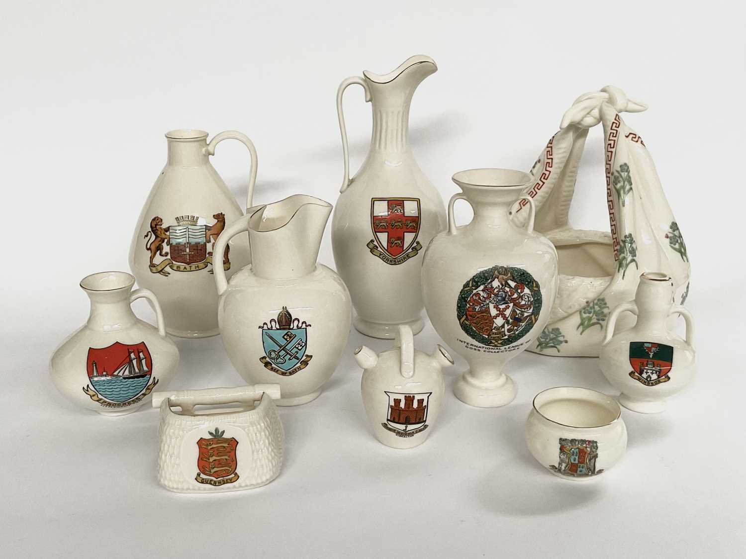 W.H. Goss, assorted crested china, various towns, shapes including a basket with fabric handle,