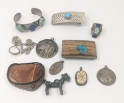 A collection of jewellery to include belt buckles and pendants etc. some mexican silver