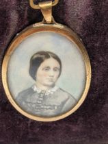 A 19th century miniature portrait of a lady, yellow metal mount, H.5.5cm