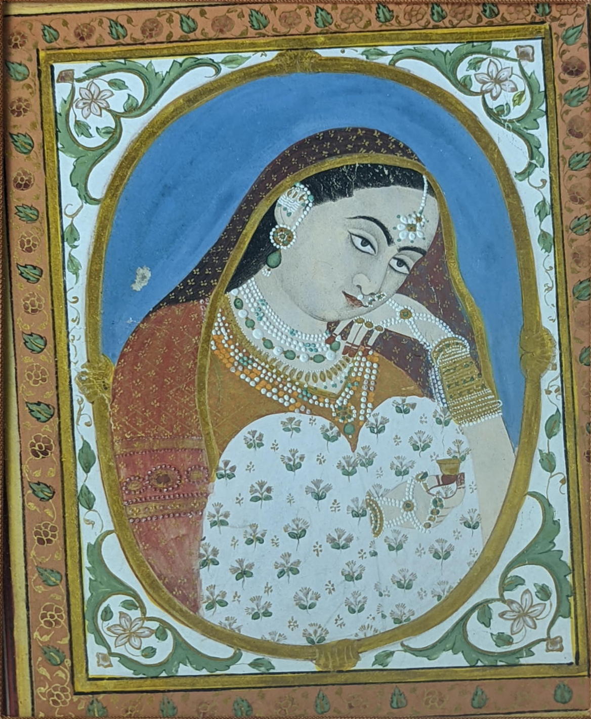 A 19th century Indian miniature painting depicting a portrait of a lady, H.12.5cm W.9cm