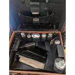 A travel vanity case with silver topped glass jars