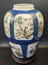 A Chinese 19th century powder blue ginger jar, paneled scenes, Kangxi marks, with wooden stand, H.