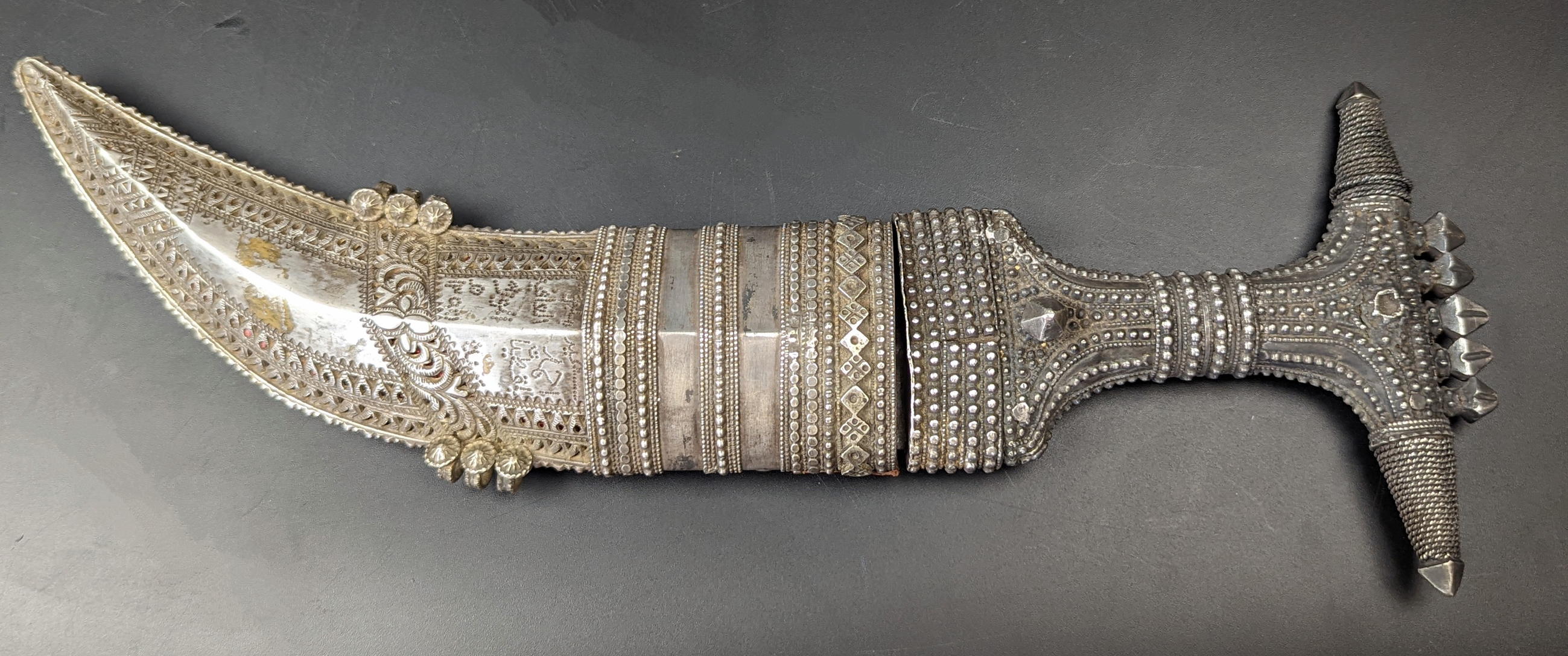A 19th century Arab Yemeni or Saudi signed silver jambiya dagger, L.26cm blade length 12.5cm