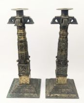 An unusual pair of 18th century Indian or Sri Lankan brass temple candlesticks, H.30cm