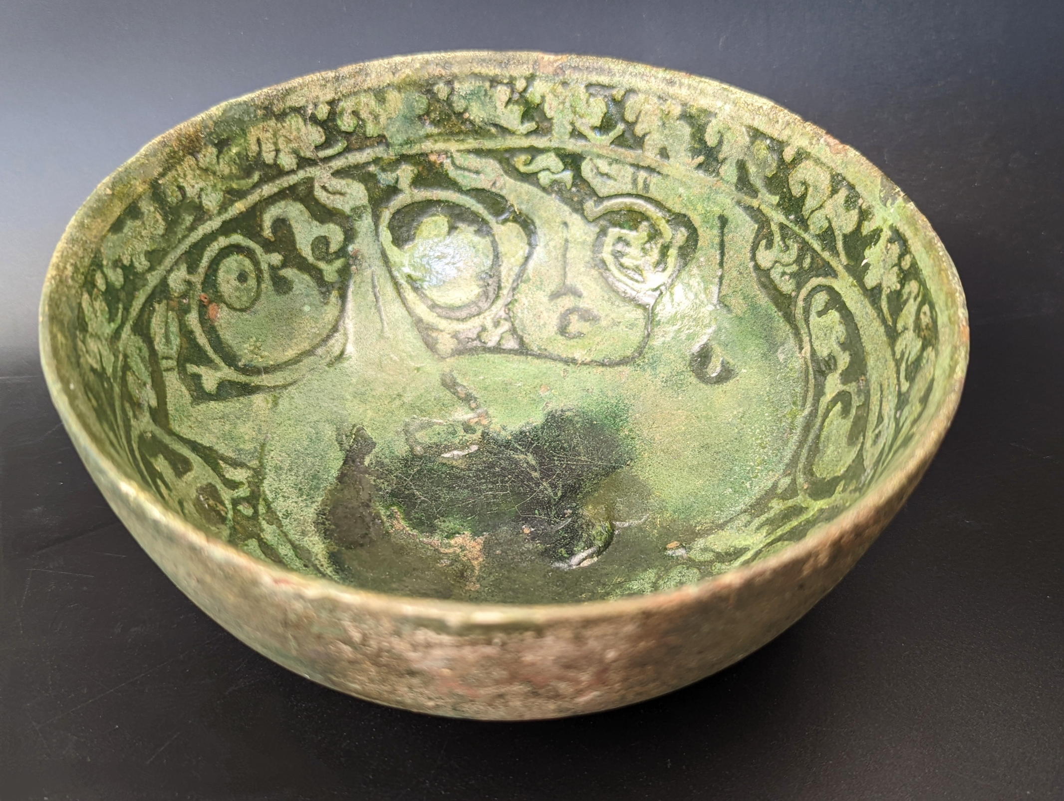 A rare 12th century Persian Garus ware green glazed pottery bowl depicting a mythical creature, H. - Image 3 of 5