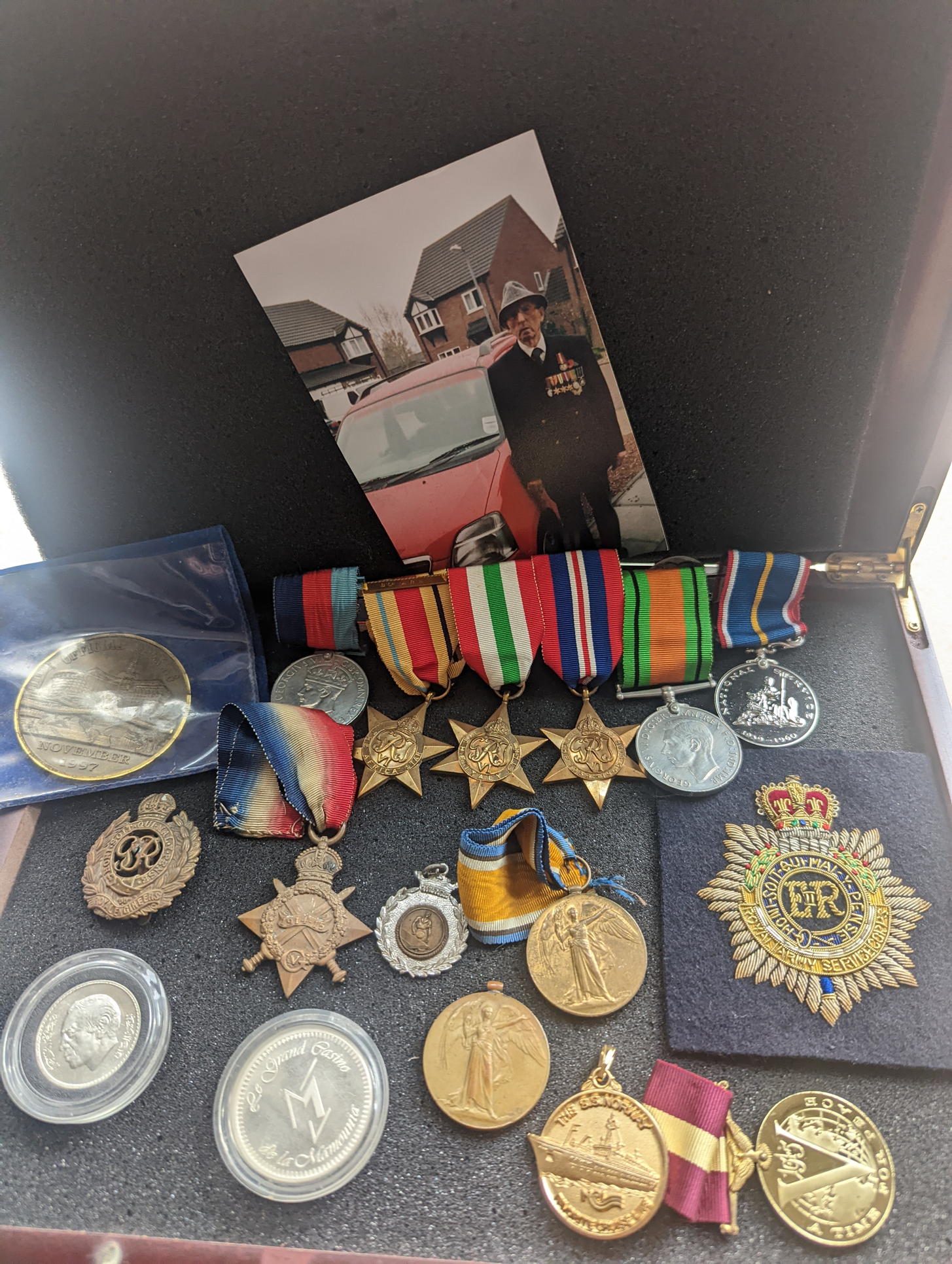 A collection of WWII military and other medals, coins to include a silver Moroccan dirham and casino