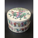 A Chinese 19th century famille rose circular pot and cover, decorated with 100 boys and two