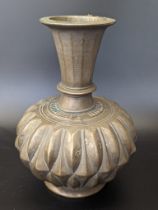 A 17th or 18th century Mughal Indian bronze gadrooned vase, H.17cm