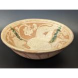 A fine possibly Persian Garus ware pottery bowl depicting a camel, H.5cm D.18cm