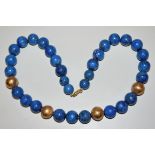 Designer lapis lazuli necklace with gold spheres