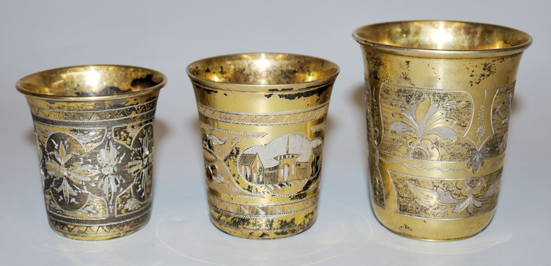 Three Russian silver cups with guilloché decoration, Moscow 1870-73