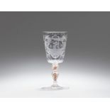 A cut glass goblet inscribed "Plus je suis agite"