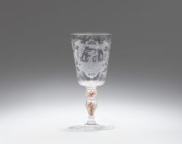 A cut glass goblet inscribed "Plus je suis agite"