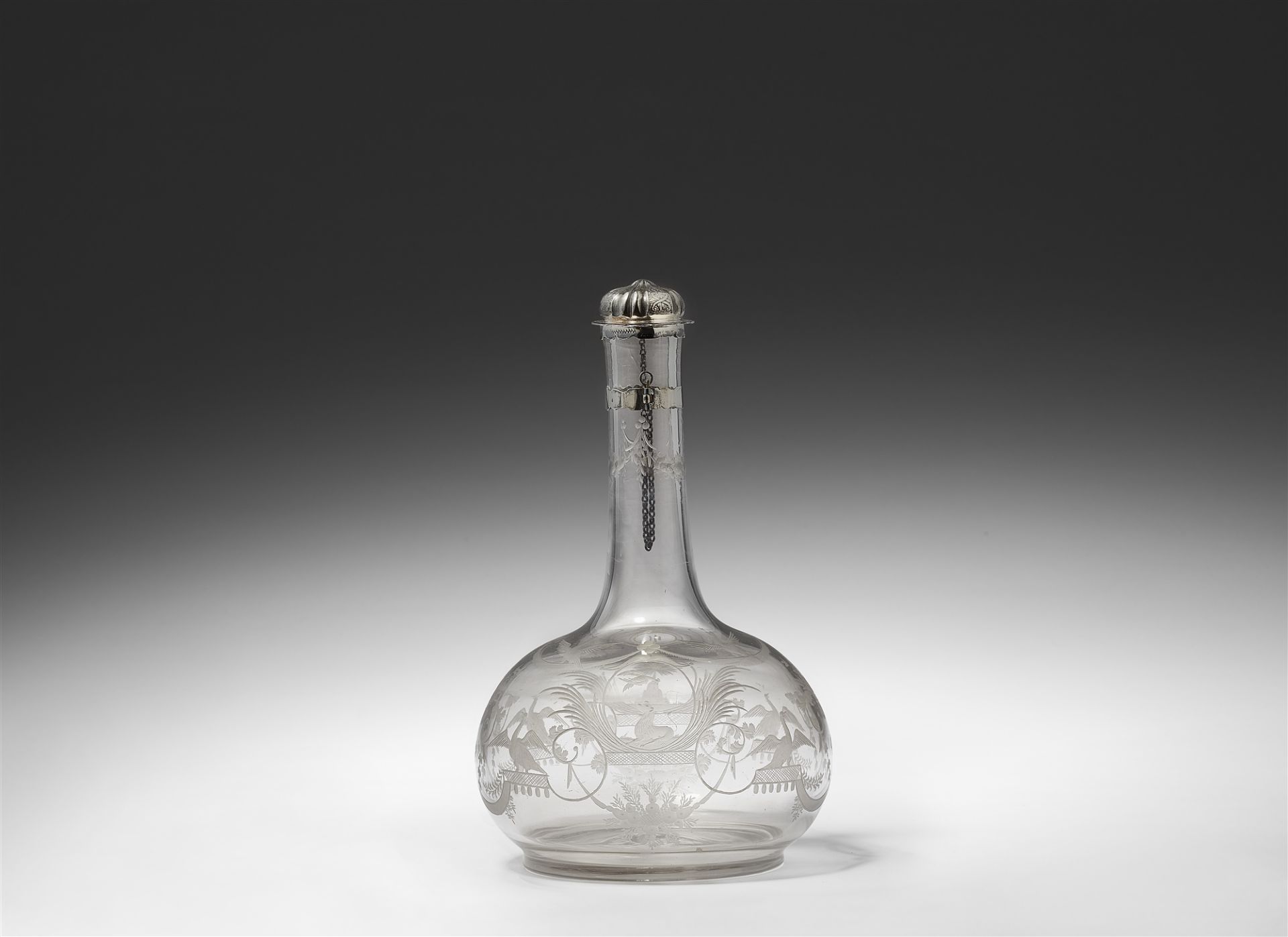 A cut glass bottle decorated in the manner of Bérain