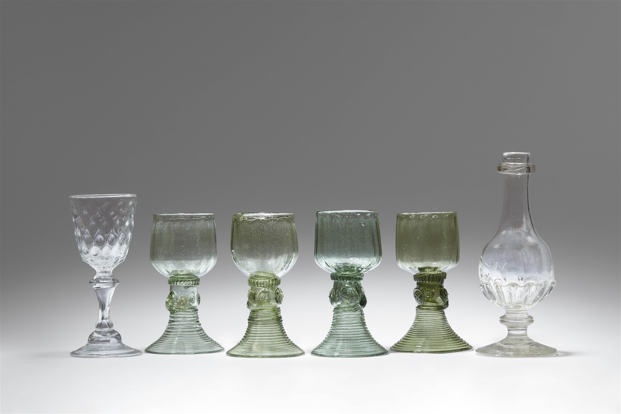 Four cut glass rummers, a goblet and a bottle