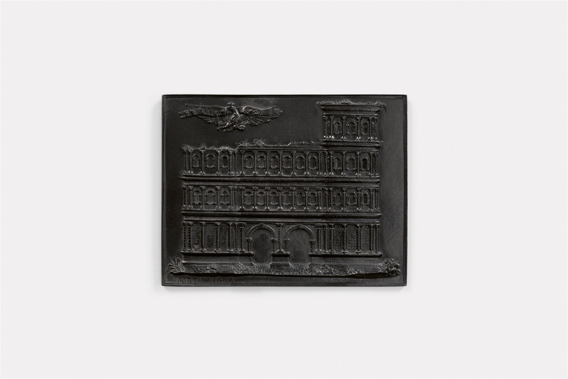 A cast iron New Year's plaque inscribed "PORTA NIGRA"