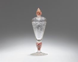 A cut glass goblet with a courtly banquet scene