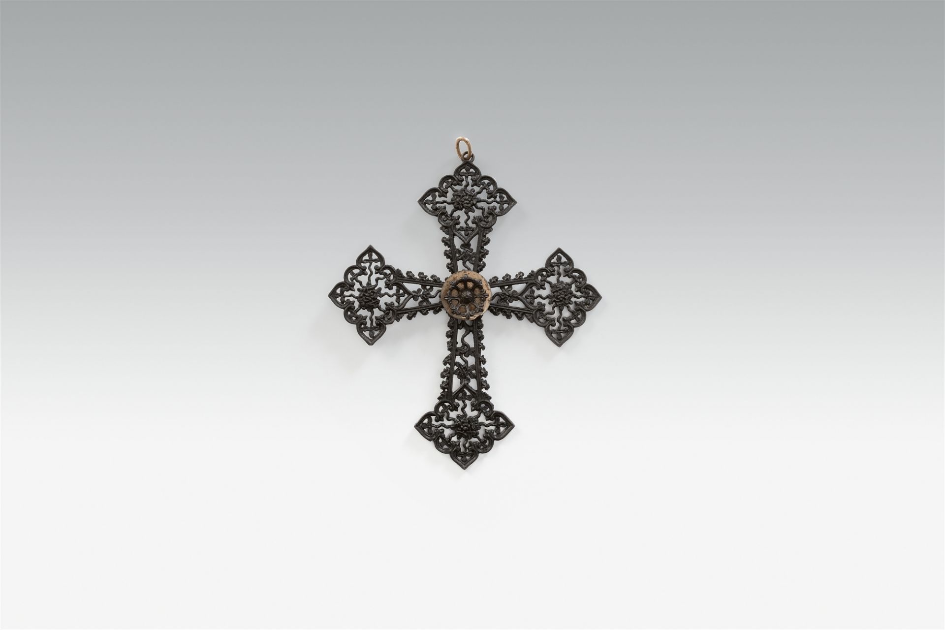 A cast iron and polished steel cross pendant
