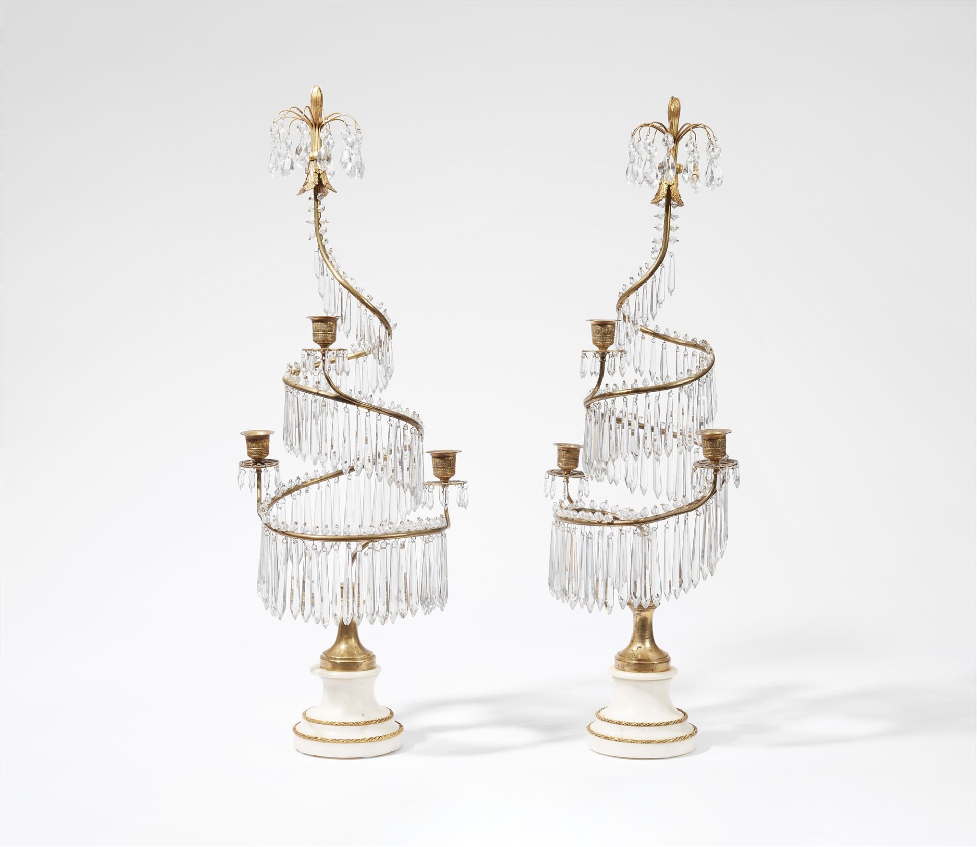 A pair of three-flame bronze candelabra