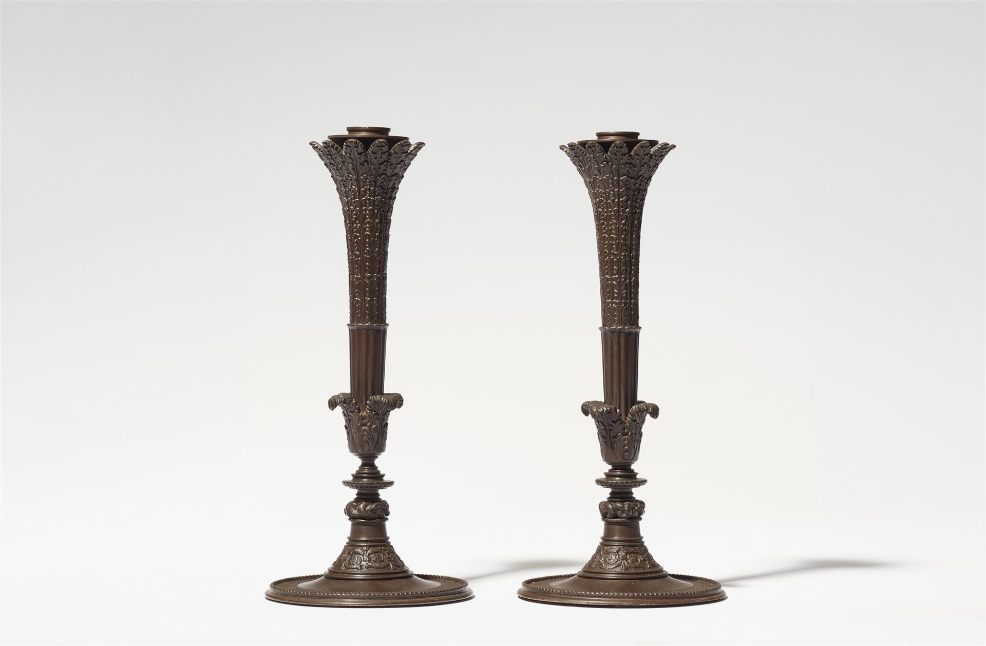 A pair of cast iron candelabra after a design by Karl Friedrich Schinkel