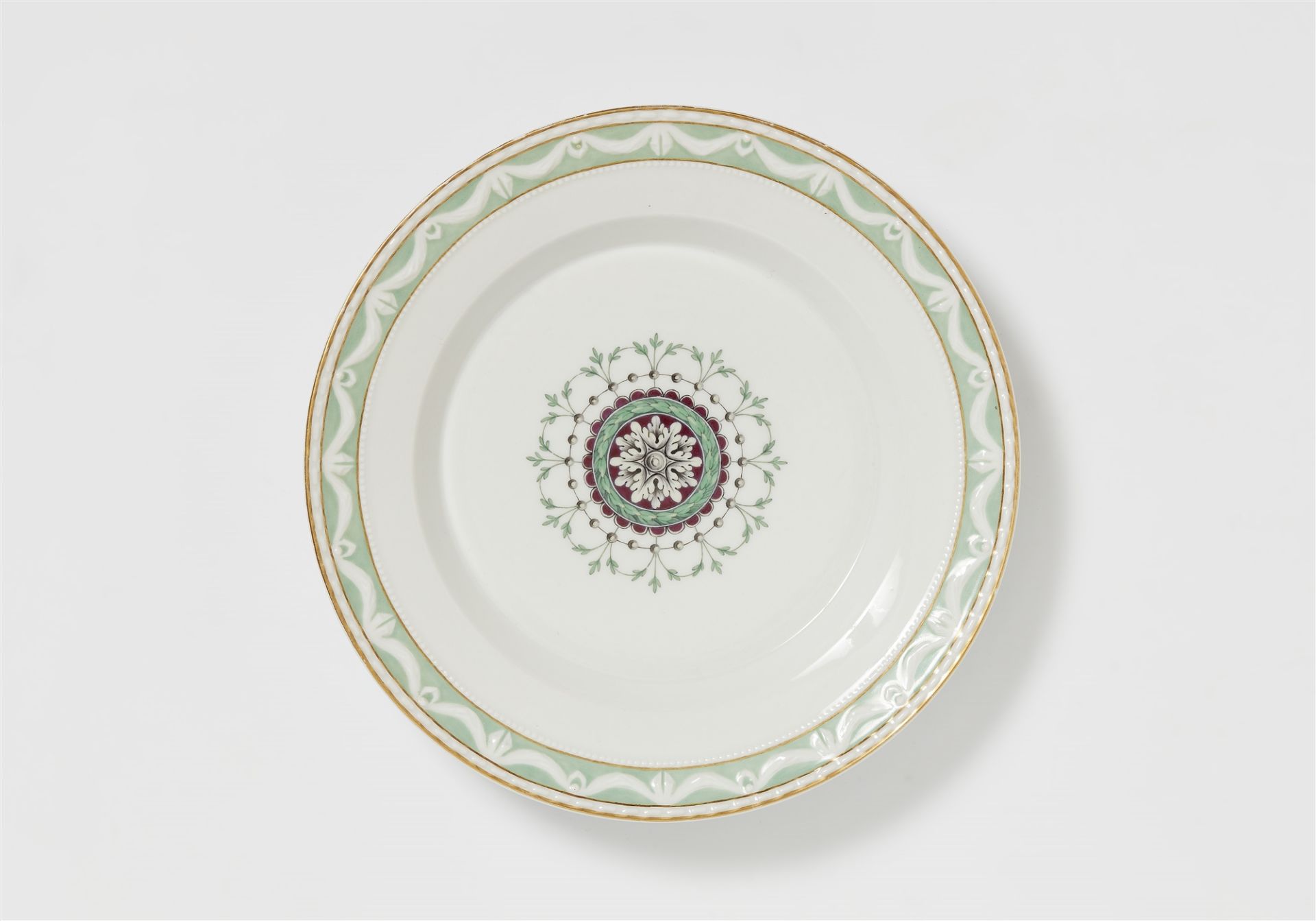 A Berlin KPM porcelain dinner plate from a service with a Neoclassical medallion motif