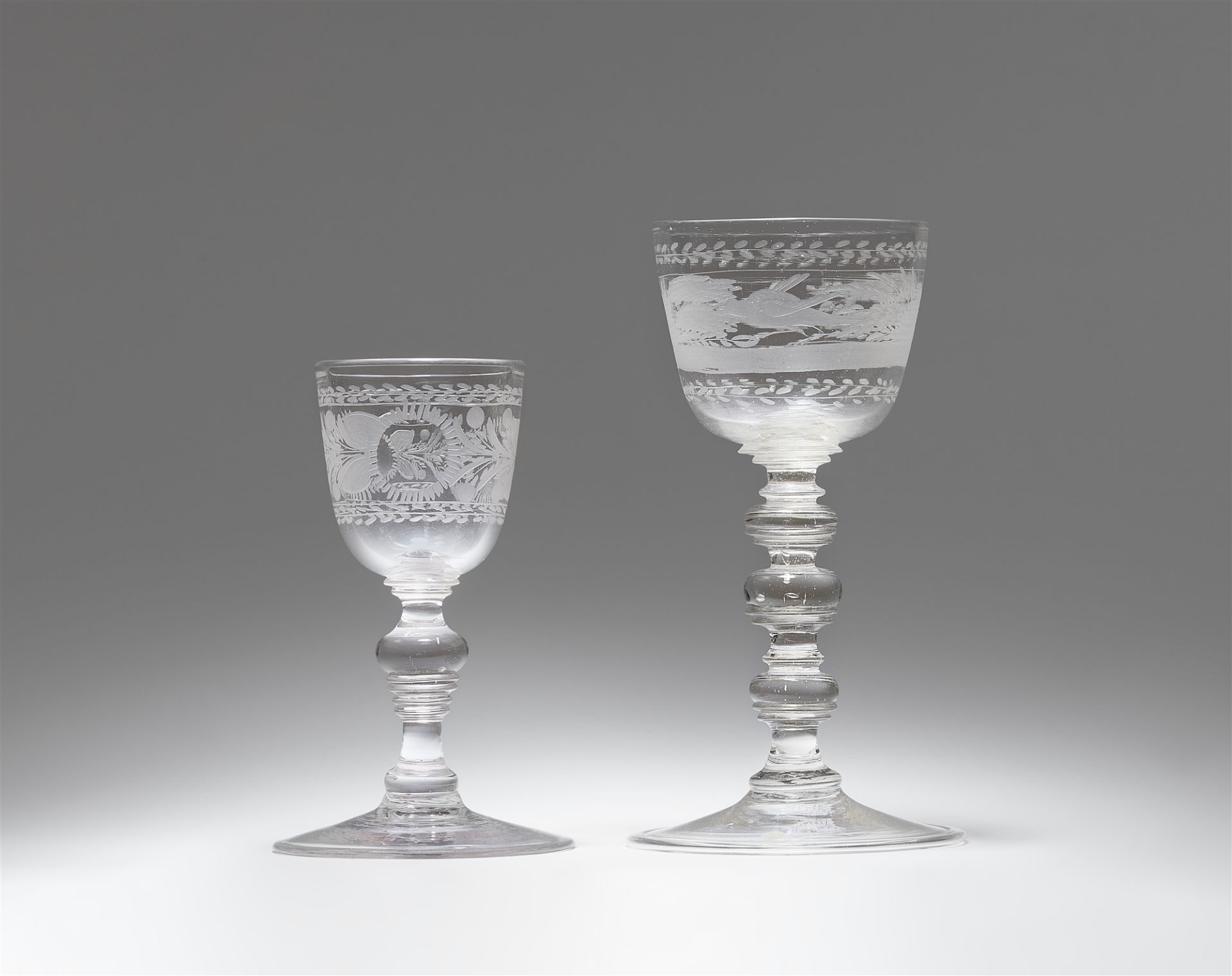 Two cut glass goblets with layered shafts