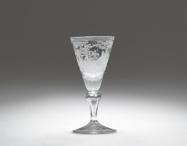 A cut glass goblet with scenes of Cupid